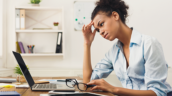 Frustrated woman looking at spreadsheets.